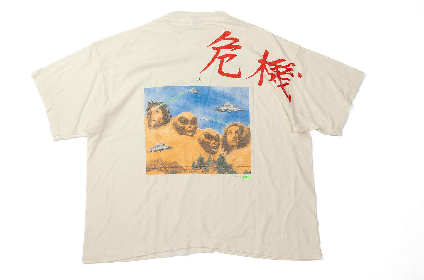 Beige t-shirt with a graphic design and red text on the back