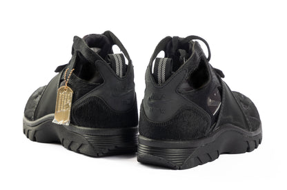 Black athletic shoes with a gold tag on a white background