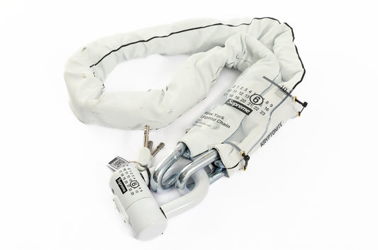 White bike lock with key on a white background