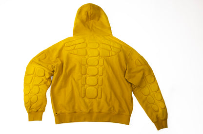 Yellow hoodie with turtle shell pattern on a white background